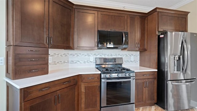 224 Adams Pointe Blvd Unit 1, Adams Twp, PA 16046 - kitchen with stainless steel appliances, backsplash, light countertops, and ornamental molding