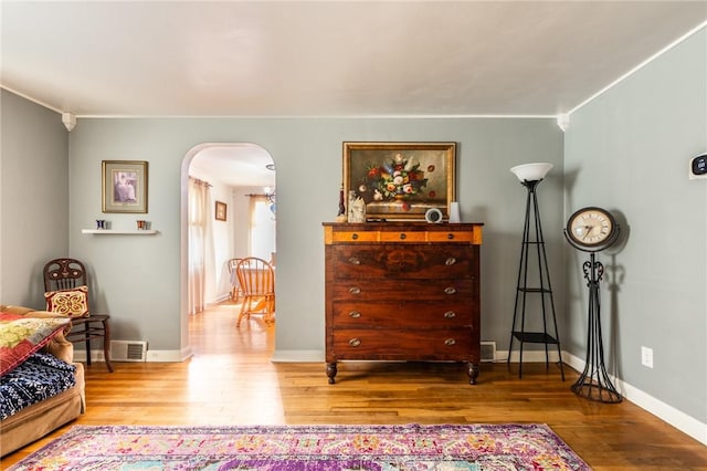 1029 3rd St, Baden, PA 15005 - sitting room with arched walkways, wood finished floors, and ornamental molding