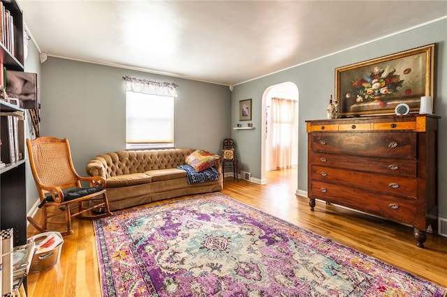 1029 3rd St, Baden, PA 15005 - living room featuring plenty of natural light, arched walkways, wood finished floors, and crown molding