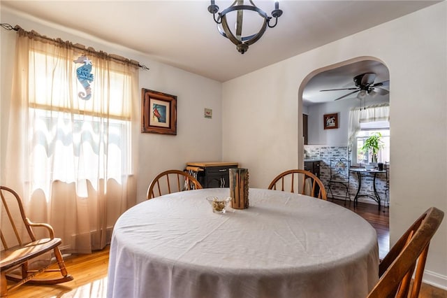 1029 3rd St, Baden, PA 15005 - dining area featuring wood finished floors, arched walkways, ceiling fan, and a chandelier