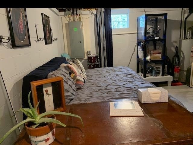 1029 3rd St, Baden, PA 15005 - bedroom with electric panel, concrete block wall, and water heater