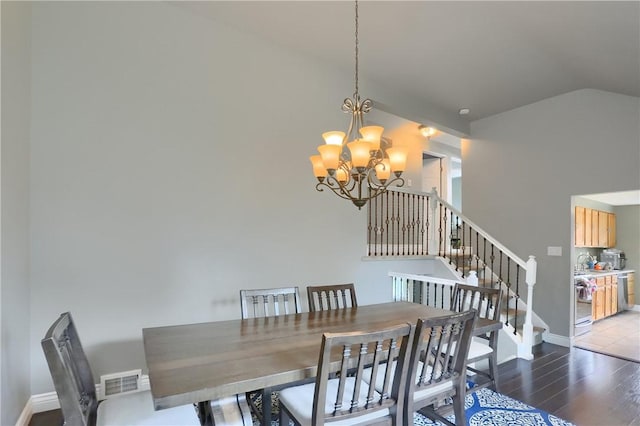 1445 Raven Dr, Pittsburgh, PA 15243 - dining room featuring a chandelier, vaulted ceiling, wood finished floors, and stairs