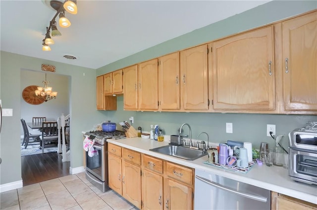 1445 Raven Dr, Pittsburgh, PA 15243 - kitchen with gas range, dishwashing machine, light countertops, a chandelier, and light brown cabinetry