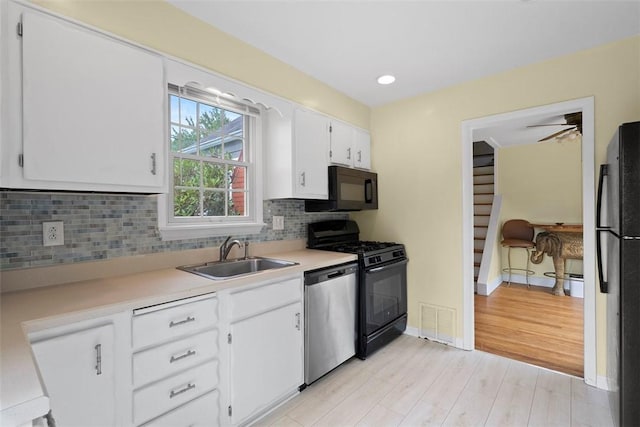 2324 Mcaleer Rd, Franklin Park, PA 15143 - kitchen with black appliances, light countertops, backsplash, white cabinetry, and recessed lighting