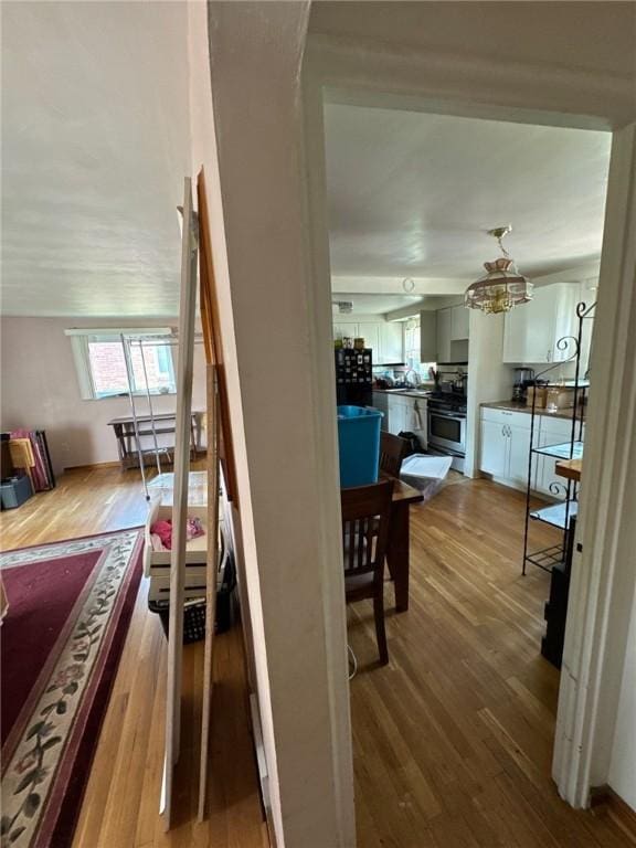 155 Roosevelt Ave, Stowe Twp, PA 15136 - stairs with wood finished floors and a chandelier