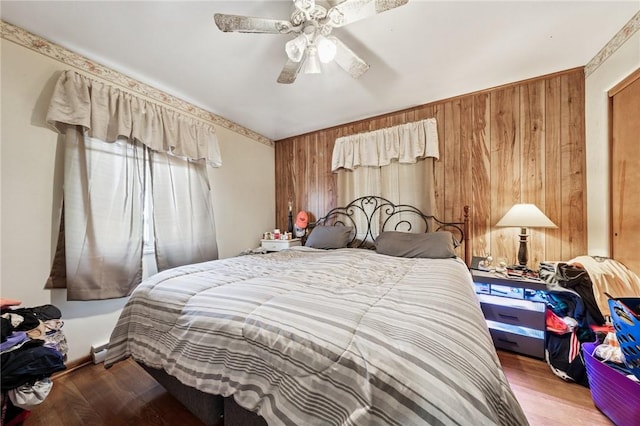 161 Thorne Dr N, Franklin Twp, PA 15301 - bedroom with wooden walls, wood finished floors, and ceiling fan