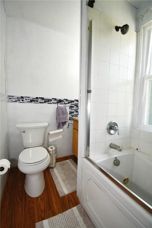 226 Johnston St, Cecil, PA 15057 - bathroom with wood finished floors, tile walls, and shower / bathtub combination