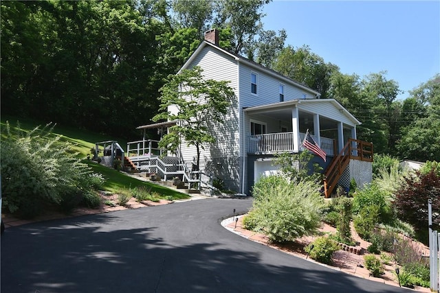 226 Johnston St, Cecil, PA 15057 - view of front of house featuring stairs, a chimney, an attached garage, and asphalt driveway