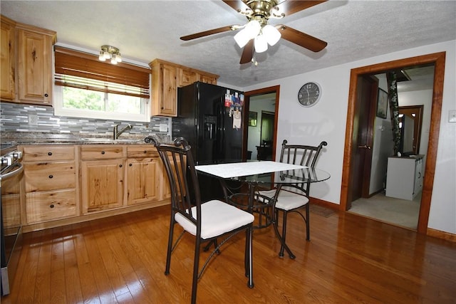 226 Johnston St, Cecil, PA 15057 - kitchen featuring black fridge, dark wood-style floors, backsplash, ceiling fan, and stainless steel range oven