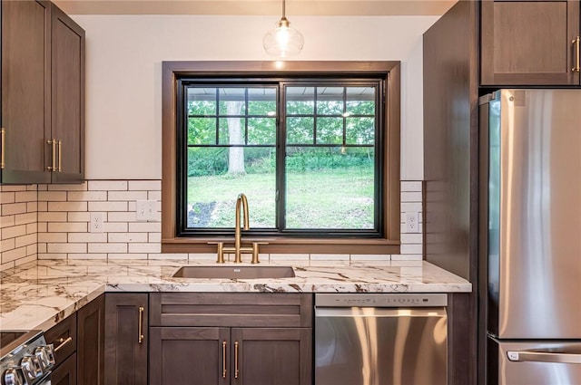 5 Bel Aire Dr, Murrysville, PA 15626 - kitchen with appliances with stainless steel finishes, decorative backsplash, light stone counters, dark brown cabinets, and hanging light fixtures
