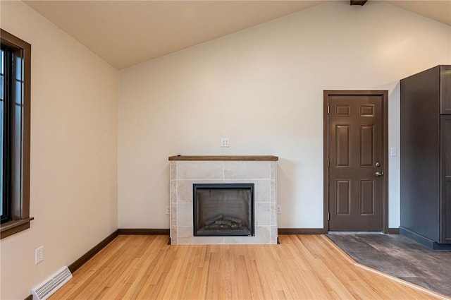 5 Bel Aire Dr, Murrysville, PA 15626 - unfurnished living room featuring lofted ceiling, light wood-style floors, and a fireplace