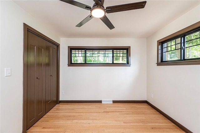 5 Bel Aire Dr, Murrysville, PA 15626 - unfurnished bedroom featuring multiple windows, light wood finished floors, a closet, and ceiling fan