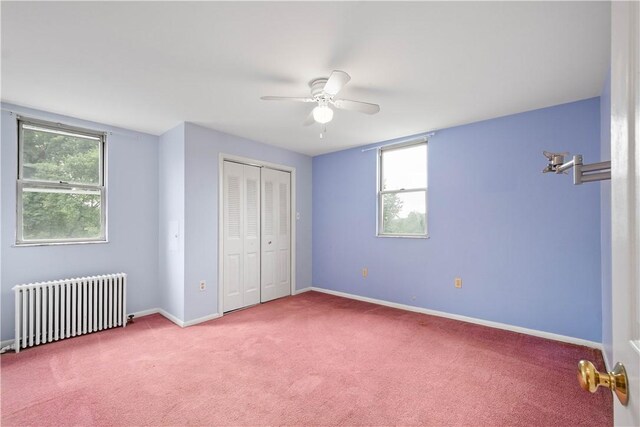 1810 Fairland St, Carrick, PA 15210 - unfurnished bedroom with radiator heating unit, multiple windows, carpet flooring, and a closet