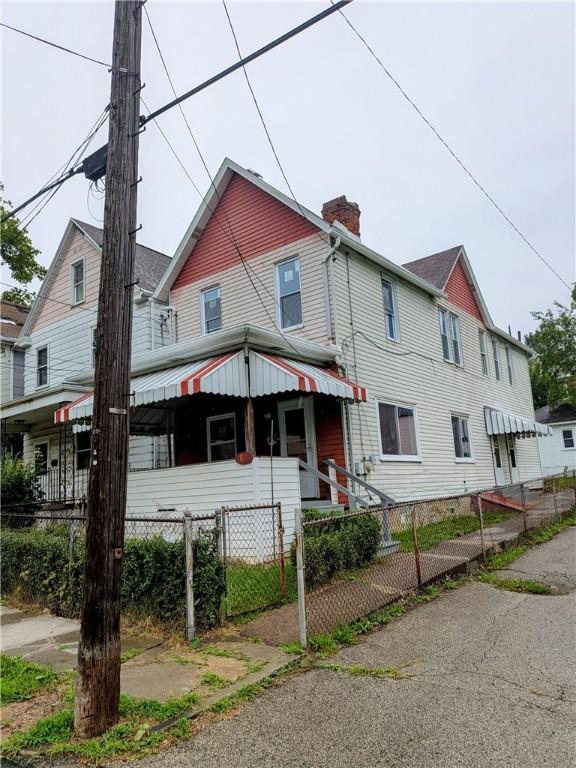 1837 Beech St, Mckeesport, PA 15132 - view of front of property featuring a chimney, a fenced front yard, and a gate