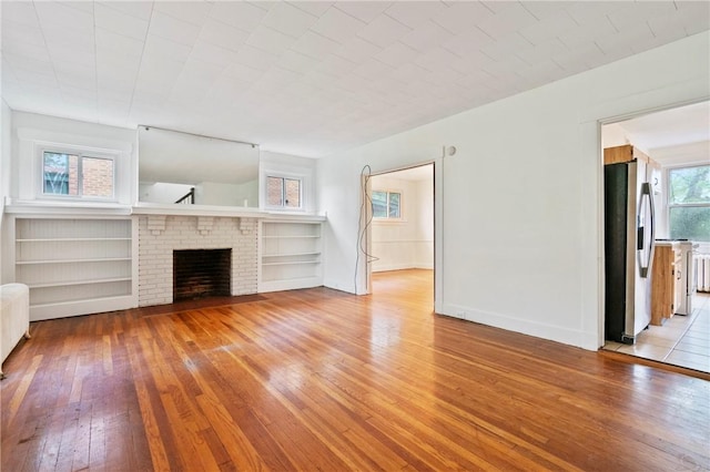 3001 Mount Allister Rd, Observatory Hill, PA 15214 - unfurnished living room with light wood-style floors and a brick fireplace