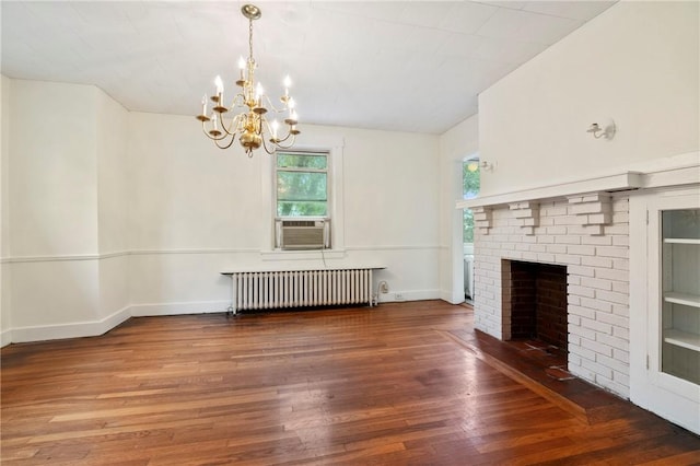 3001 Mount Allister Rd, Observatory Hill, PA 15214 - unfurnished living room featuring radiator heating unit, a chandelier, wood finished floors, cooling unit, and a brick fireplace