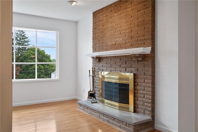 315 Olive St, Mccandless, PA 15237 - unfurnished living room with heating unit, plenty of natural light, a fireplace, and light wood-type flooring