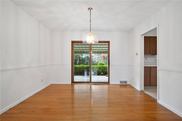 315 Olive St, Mccandless, PA 15237 - unfurnished dining area with a chandelier and light wood-style flooring