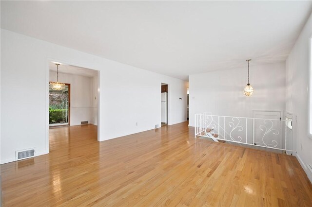 315 Olive St, Mccandless, PA 15237 - unfurnished room with light wood-style floors and a chandelier