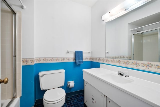 315 Olive St, Mccandless, PA 15237 - bathroom featuring vanity, a wainscoted wall, and bath / shower combo with glass door