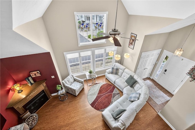 1049 Waterford Ct E, North Strabane, PA 15317 - living area featuring high vaulted ceiling, a ceiling fan, and wood finished floors