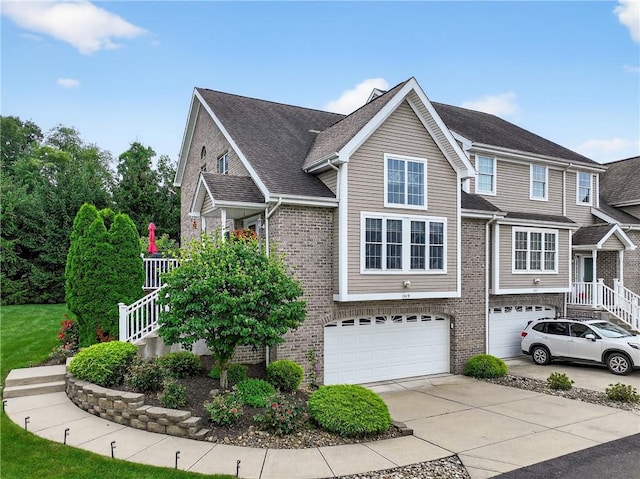 1049 Waterford Ct E, North Strabane, PA 15317 - view of front of home featuring a garage, concrete driveway, and brick siding