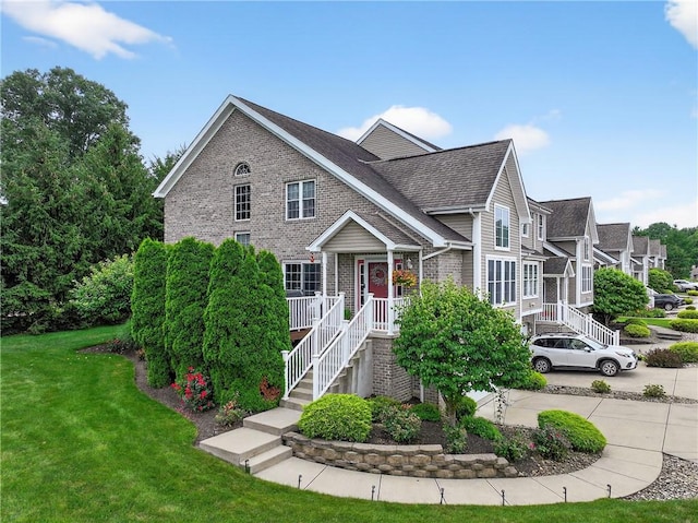 1049 Waterford Ct E, North Strabane, PA 15317 - traditional-style house with brick siding, a front yard, and roof with shingles