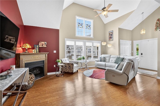 1049 Waterford Ct E, North Strabane, PA 15317 - living area with high vaulted ceiling, a ceiling fan, wood finished floors, a fireplace, and plenty of natural light
