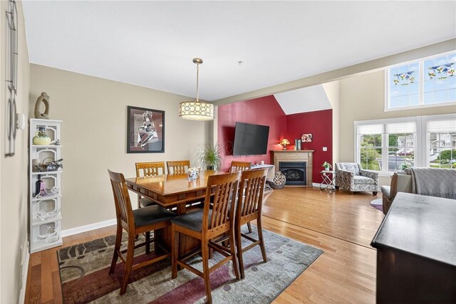 1049 Waterford Ct E, North Strabane, PA 15317 - dining area with light wood-style floors, a fireplace, and vaulted ceiling