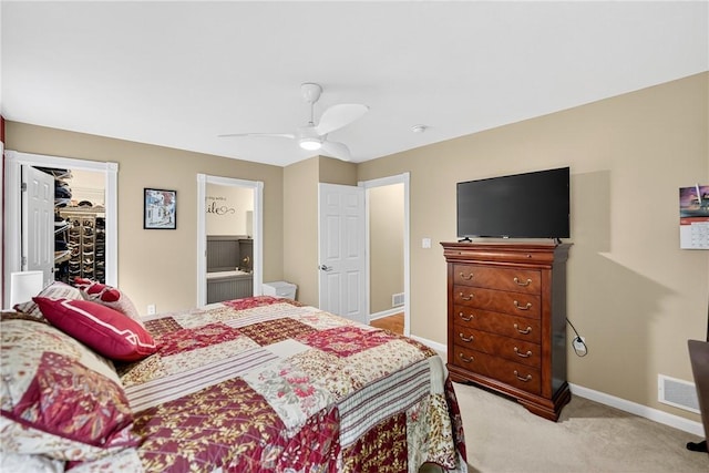 1049 Waterford Ct E, North Strabane, PA 15317 - bedroom featuring a spacious closet, light colored carpet, ceiling fan, and connected bathroom