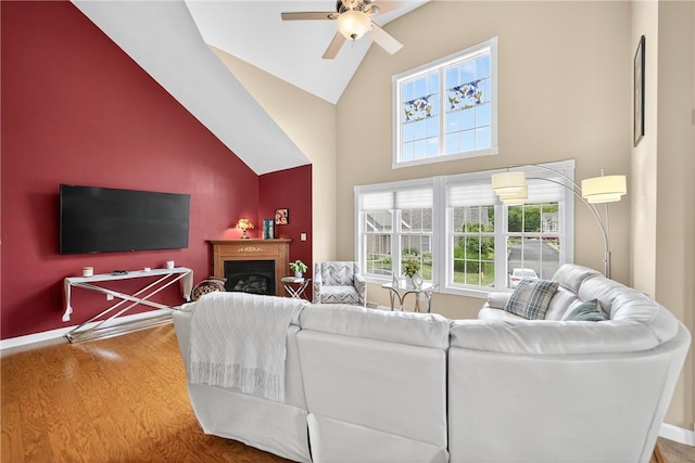 1049 Waterford Ct E, North Strabane, PA 15317 - living area with high vaulted ceiling, a ceiling fan, wood finished floors, and a fireplace