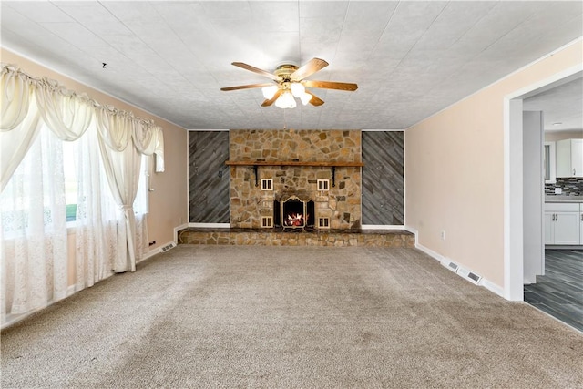 5342 Pleasant Unity Rd, Latrobe, PA 15650 - unfurnished living room with a ceiling fan, carpet, a stone fireplace, and wooden walls