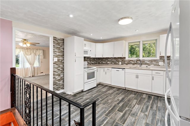 5342 Pleasant Unity Rd, Latrobe, PA 15650 - kitchen with white appliances, tasteful backsplash, light countertops, white cabinets, and recessed lighting