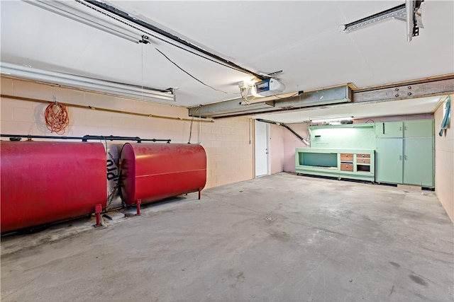 5342 Pleasant Unity Rd, Latrobe, PA 15650 - garage with oil tank, a garage door opener, and concrete block wall