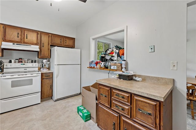 53 Fountain St, Crafton, PA 15205 - kitchen featuring white appliances, under cabinet range hood, brown cabinetry, and light countertops