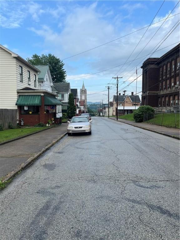 214 E Fairview Ave, Connellsville, PA 15425 - view of asphalt road featuring sidewalks, curbs, and a residential view