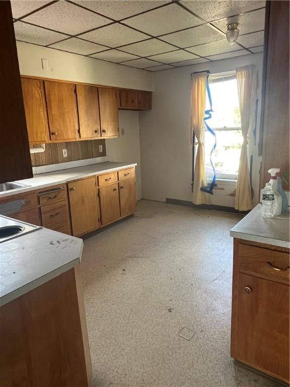 214 E Fairview Ave, Connellsville, PA 15425 - kitchen with brown cabinets, light countertops, and a paneled ceiling