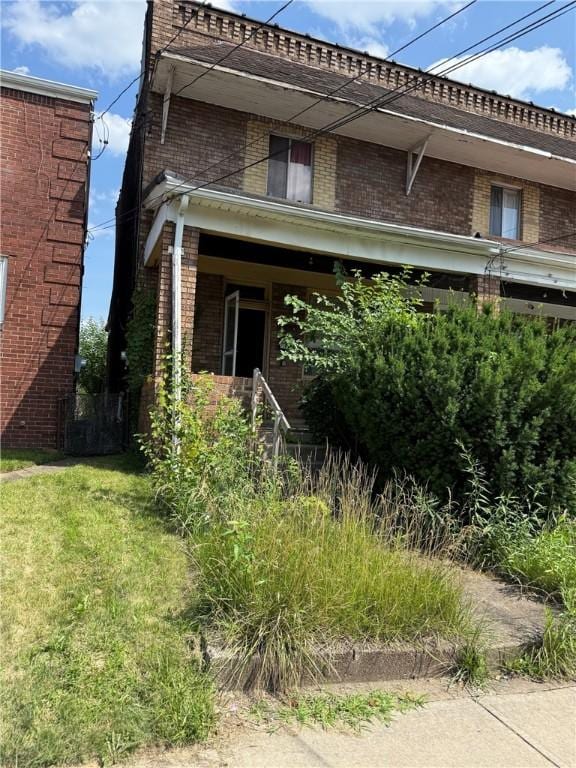 7514 Roslyn St, Swissvale, PA 15218 - view of front of home with brick siding and a front yard
