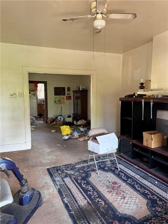 7514 Roslyn St, Swissvale, PA 15218 - living area with unfinished concrete flooring and a ceiling fan