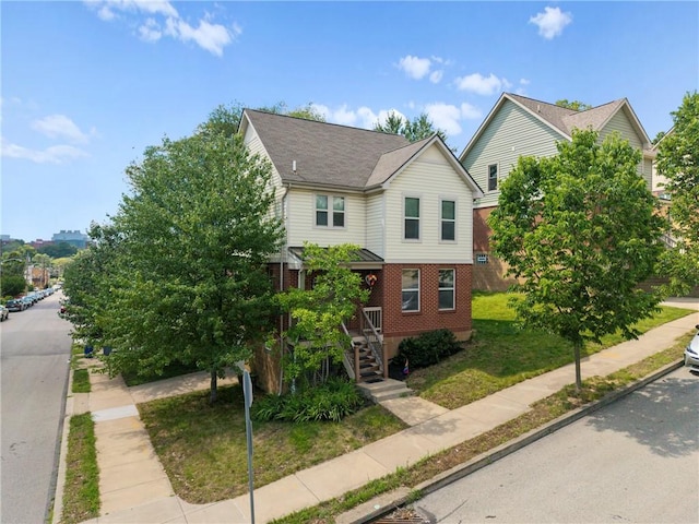 301 N Winebiddle St, Garfield, PA 15224 - view of front of home with brick siding and a front lawn