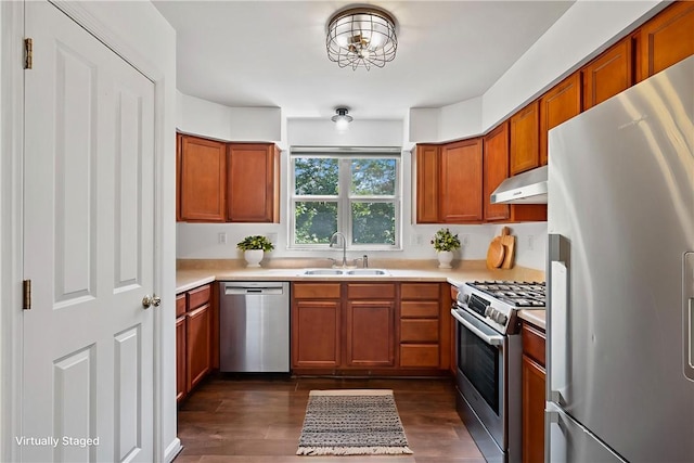 301 N Winebiddle St, Garfield, PA 15224 - kitchen featuring appliances with stainless steel finishes, under cabinet range hood, light countertops, and dark wood finished floors