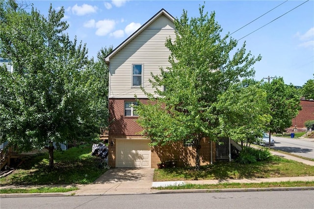 301 N Winebiddle St, Garfield, PA 15224 - view of front of home with brick siding, concrete driveway, and an attached garage