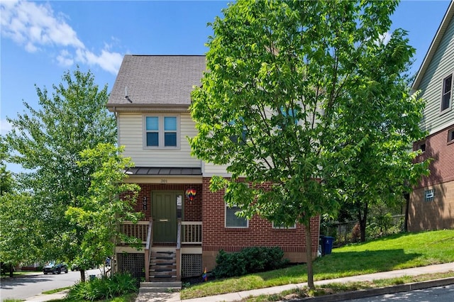 301 N Winebiddle St, Garfield, PA 15224 - view of front of house featuring brick siding, a front yard, and a porch