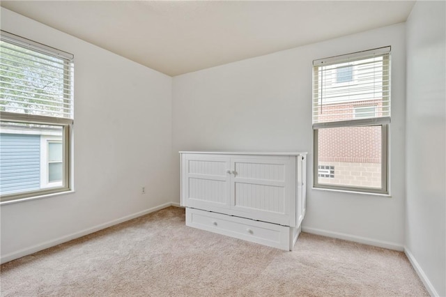 301 N Winebiddle St, Garfield, PA 15224 - unfurnished bedroom with multiple windows and carpet floors