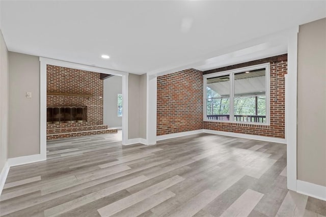 1082 N Boundary, Cranberry Twp, PA 16066 - unfurnished living room with brick wall, a brick fireplace, and wood finished floors