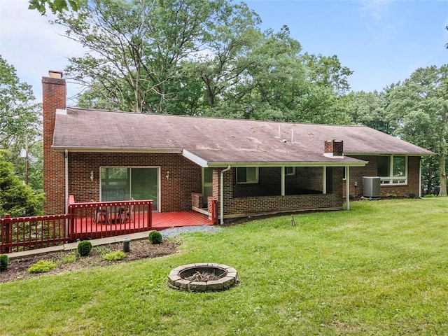 1082 N Boundary, Cranberry Twp, PA 16066 - view of front of property with an outdoor fire pit, a chimney, a deck, a front yard, and brick siding