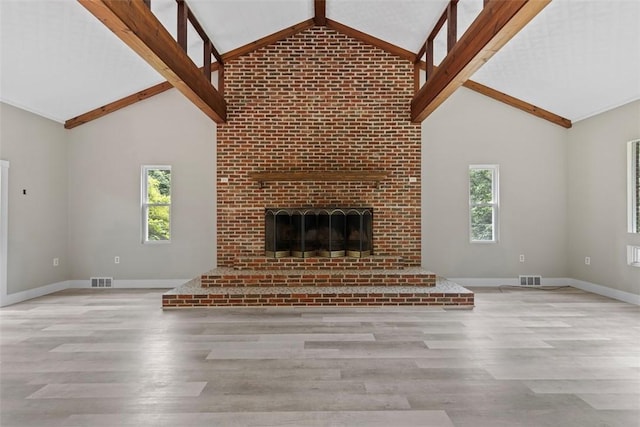 1082 N Boundary, Cranberry Twp, PA 16066 - unfurnished living room featuring wood finished floors, high vaulted ceiling, plenty of natural light, beamed ceiling, and a fireplace