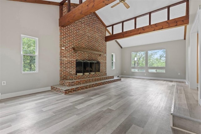 1082 N Boundary, Cranberry Twp, PA 16066 - unfurnished living room featuring high vaulted ceiling, ceiling fan, healthy amount of natural light, wood finished floors, and a fireplace