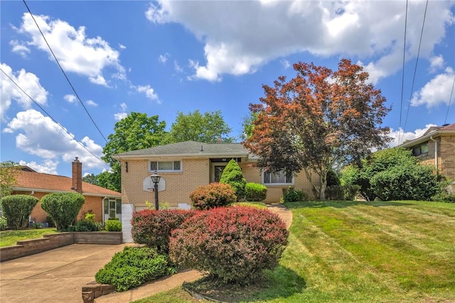 1919 Outlook Dr, Penn Hills, PA 15147 - view of front of home with brick siding, a front lawn, and concrete driveway