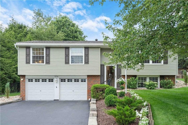 1214 Regency Dr, Mccandless, PA 15237 - bi-level home with asphalt driveway, brick siding, a front lawn, and an attached garage